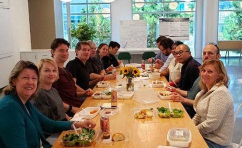 Large group of coworkers dining at a table